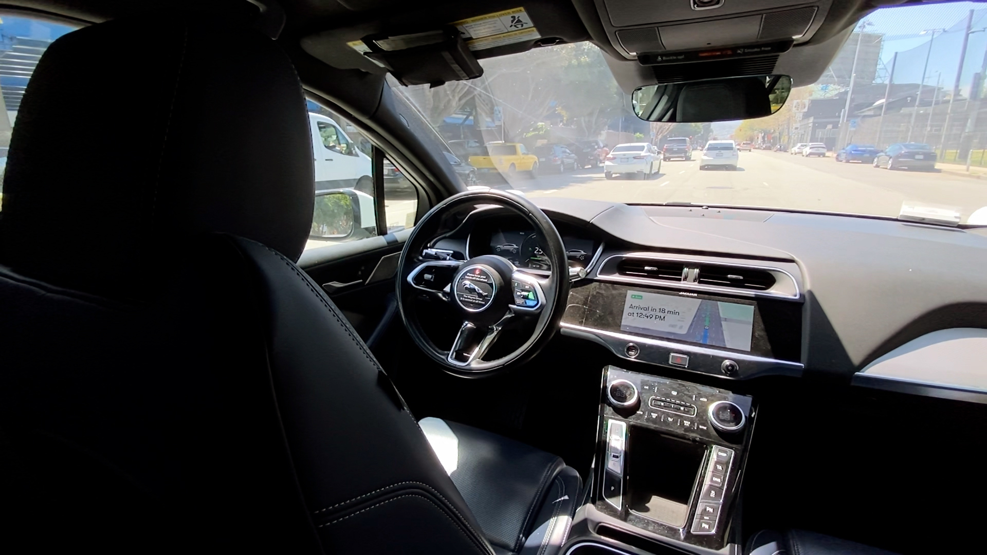A look inside a Waymo self-driving vehicle with an empty driver's seat as it travels along a San Francisco street.