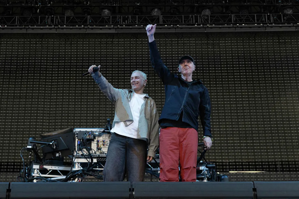 Karl Hyde and Rick Smith of Underworld wave to the crowd during their set on the Pier Stage at the Portola Music Festival on Pier 80 in San Francisco, Calif. on Sept. 21, 2025. (Douglas Zimmerman/SFGATE)