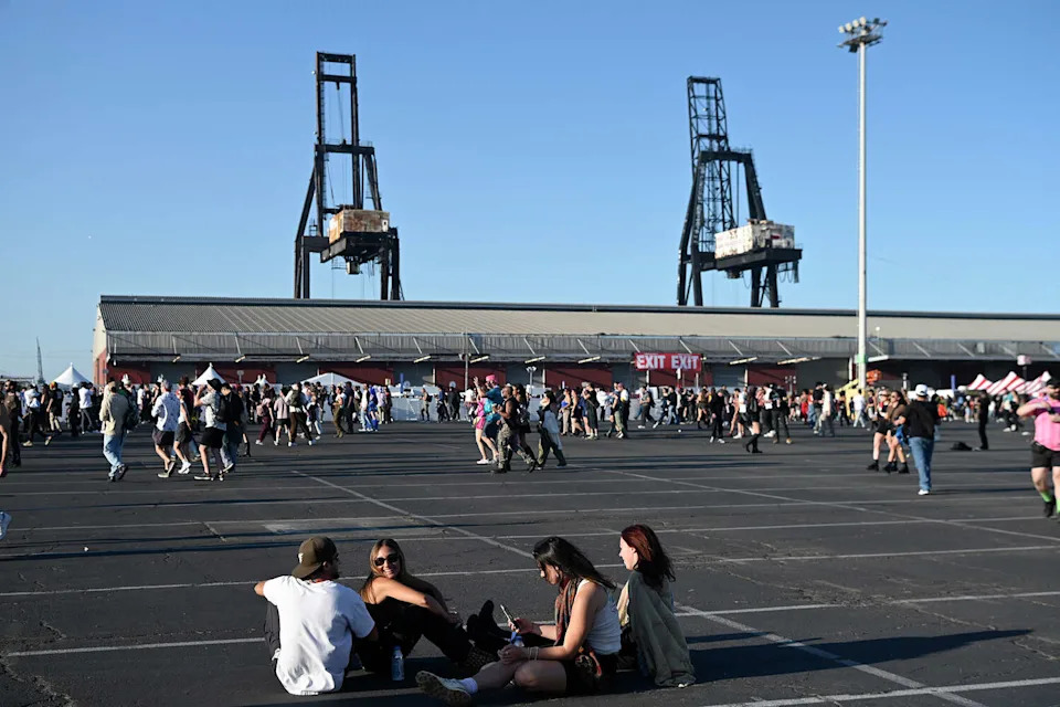 Concertgoers sit on the concrete at Pier 80 during the Portola Music Festival on Saturday Sept. 20, 2025. (Charles Russo/SFGATE)