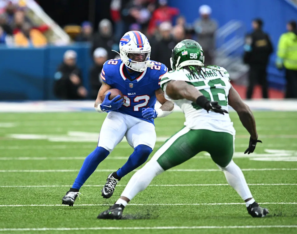 Dec 29, 2024; Orchard Park, New York, USA; Buffalo Bills running back Ray Davis (22) tries to maneuver past New York Jets linebacker Quincy Williams (56) in the second quarter at Highmark Stadium. Mandatory Credit: Mark Konezny-Imagn Images