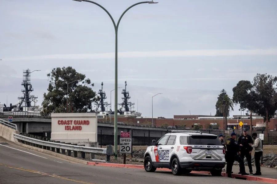 Security members are seen by the bridge that leads to Coast Guard Island Alameda in Oakland on Oct. 22, 2025. (Photo by Stephen Lam/San Francisco Chronicle via Getty Images)
