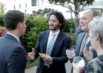 Zac Bookman, center, speaks with Daniel Lurie at the ceremony for the Chronicle's