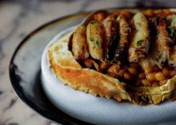 The whole Dungeness crab with fregola risotto, crab fat, uni butter and Meyer lemon-glazed crab legs at Bourbon Steak. (Yalonda M. James/S.F. Chronicle)