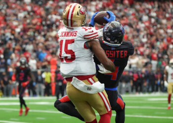 Oct 26, 2025; Houston, Texas, USA; Houston Texans cornerback Kamari Lassiter (4) intercepts a pass intended for San Francisco 49ers wide receiver Jauan Jennings (15) during the fourth quarter at NRG Stadium. Mandatory Credit: Troy Taormina-Imagn Images