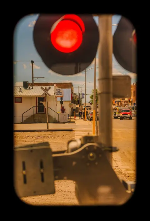 Katie Edwards The red light of a rail crossing in Cutbank, a town in Montana that began in 1891 with the arrival of the Great Northern Railway

