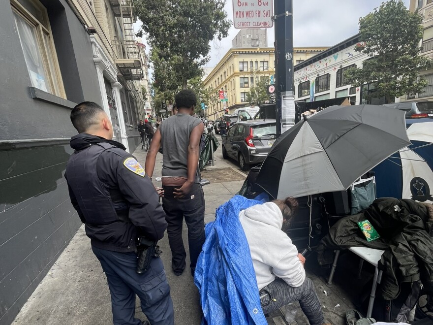 San Francisco police officers detain a man for 