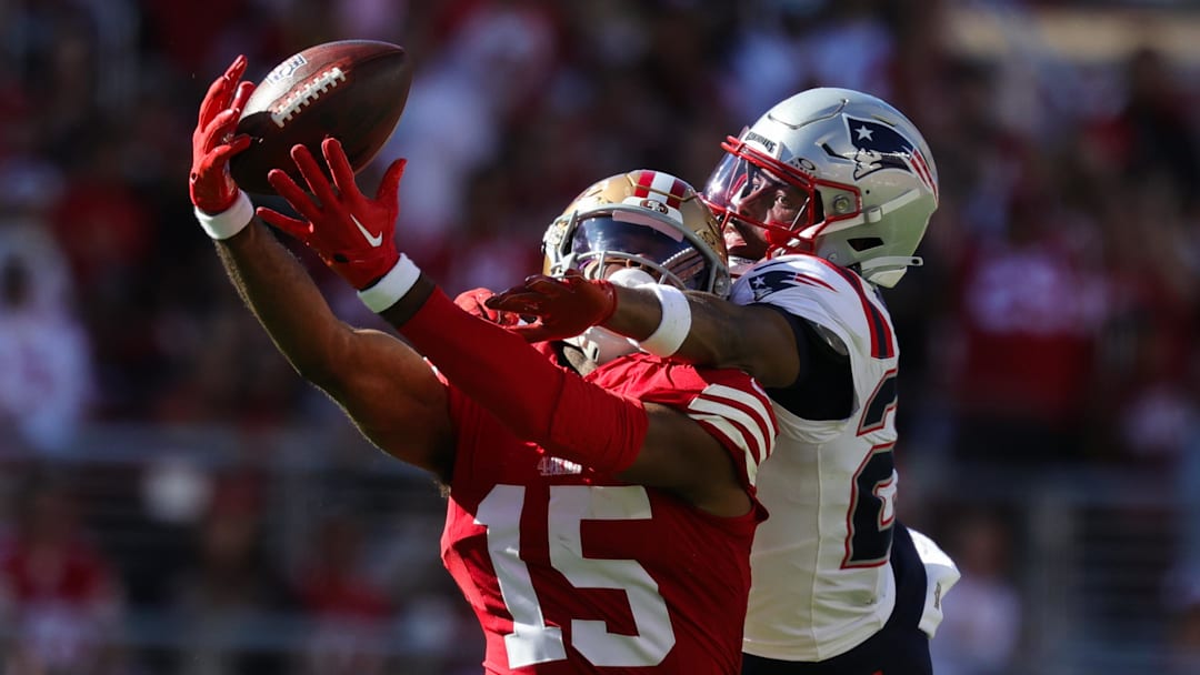 Sep 29, 2024; Santa Clara, California, USA; San Francisco 49ers wide receiver Jauan Jennings (15) stretches out for a catch against New England Patriots cornerback Marcus Jones (25) during the fourth quarter at Levi's Stadium. Mandatory Credit: Sergio Estrada-Imagn Images