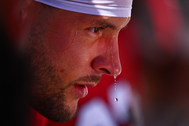 Water drips from the nose of San Francisco 49ers' Nick Bosa (97) as he sits on the bench in the first quarter of their NFL game at Levi's Stadium in Santa Clara, Calif., on Sunday, Oct. 6, 2024. The field temperature at the start of the game was near 112 degrees. (Jose Carlos Fajardo/Bay Area News Group)