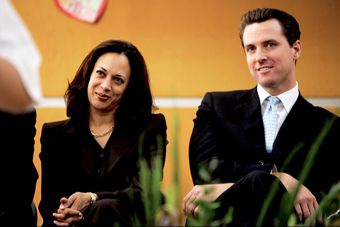 San Francisco District Attorney Kamala Harris and Mayor Gavin Newsom watch students perform