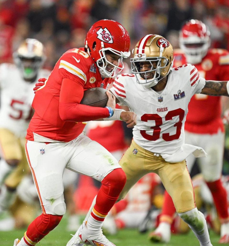 Kansas City Chiefs quarterback Patrick Mahomes (15) scrambles for yardage past San Francisco 49ers safety Logan Ryan (33) in the third quarter of Super Bowl LVIII, Sunday, Feb. 11, 2024, in Las Vegas.