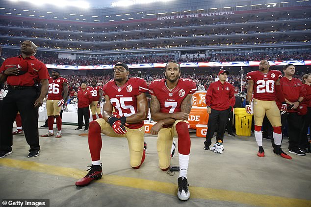 Eric Reid #35 and Colin Kaepernick #7 of the San Francisco 49ers kneel during the anthem